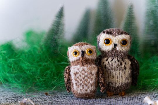 Knitted owl toy with yarn and knitting accessories - Powered by Adobe