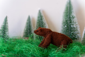 Knitted bear toy with yarn and knitting accessories