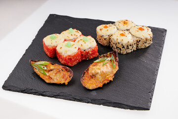 Close-up of sushi rolls made of sausage and covered with cabbage and ketchup. Homemade asian style. Sushi-food hybrids trend. Japanese food.