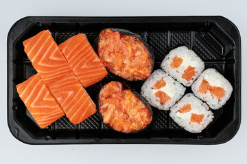 Close-up of sushi rolls made of sausage and covered with cabbage and ketchup. Homemade asian style. Sushi-food hybrids trend. Japanese food.