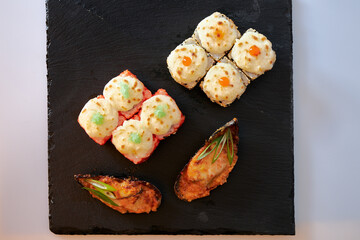 Close-up of sushi rolls made of sausage and covered with cabbage and ketchup. Homemade asian style. Sushi-food hybrids trend. Japanese food.