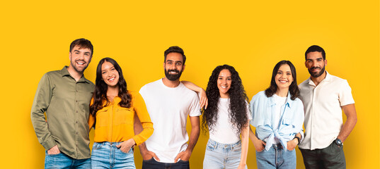 Five cheerful friends with casual outfits smiling and standing close together - obrazy, fototapety, plakaty