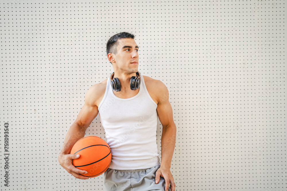 Canvas Prints Portrait of strong athlete man hold basketball ball wear white a-shirt