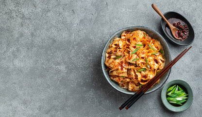 Garlic Chili Oil Noodles on a concrete background, traditional chinese dish, szechuan cuisine, top view, copy space
