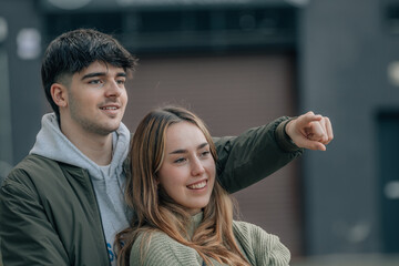 urban young couple on the street pointing