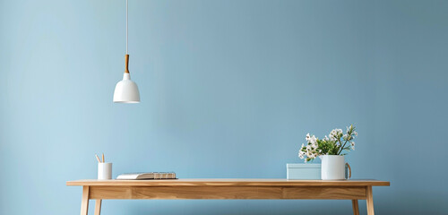 Scandinavian study space, oak desk, powder blue wall, pendant light.
