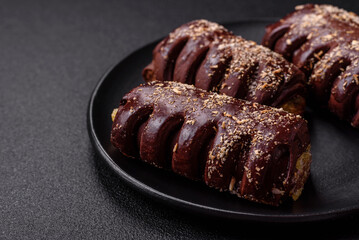 Delicious sweet chocolate cakes with fruit filling and sprinkles on a ceramic plate