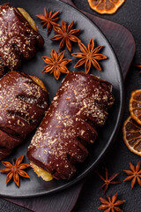 Delicious sweet chocolate cakes with fruit filling and sprinkles on a ceramic plate