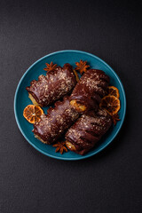 Delicious sweet chocolate cakes with fruit filling and sprinkles on a ceramic plate