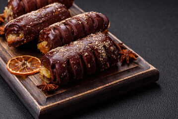 Delicious sweet chocolate cakes with fruit filling and sprinkles on a ceramic plate