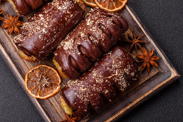 Delicious sweet chocolate cakes with fruit filling and sprinkles on a ceramic plate