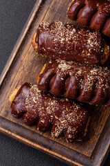 Delicious sweet chocolate cakes with fruit filling and sprinkles on a ceramic plate