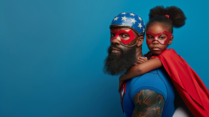 dfather wearing a helmet with an American flag design and red goggles gives a piggyback ride to his daughter, who wears a red superhero cape and goggles, both smiling widely against a clear blue sky.