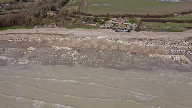 Aerial video of Atherington and Climping beach in West Sussex and the broken sea defence and the temporary shingle bank in place to protect the land.