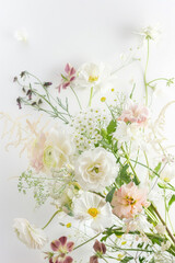 A sophisticated arrangement of exquisite flowers on white backdrop