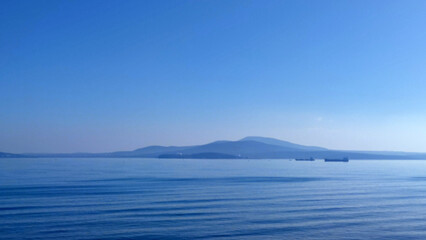 Obraz premium drifting barges in the Black Sea waters of Burgas Bulgaria, seascape in a blue haze