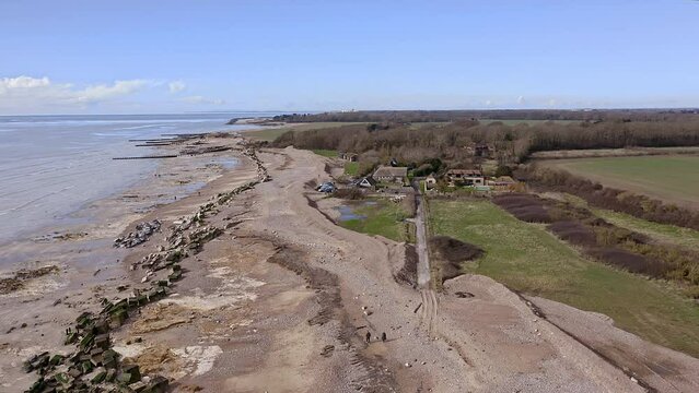 Aerial of Atherington and Climping beach in West Sussex and the broken sea defence and the temporary shingle bank in place to protect the land.