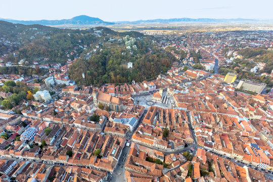 Aerial view of the Old Town city center, Brasov, Transylvania, Romania. Council Square, Black Church and White Tower at golden hour.