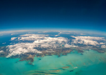 An aerial view of the Turks and Caicos Islands from an airplane window