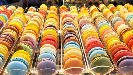 Large collection of colorful macarons in a display window