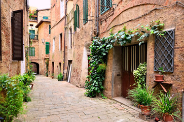 Beautiful street in the medieval old town of Siena, Tuscany, Italy
