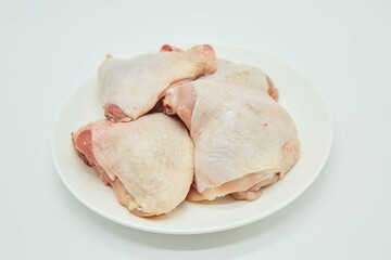 Raw meat chicken thighs on a white background. Different parts of meat products for different dishes.