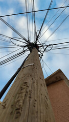 Electricity powered pole on a blue sky