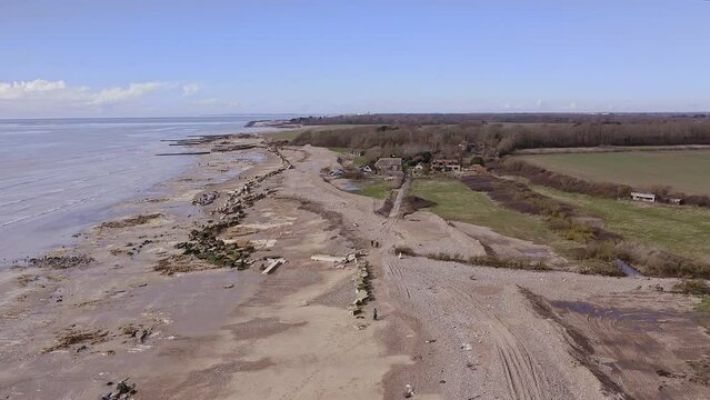 Aerial footage of Atherington and Climping beach in West Sussex and the damaged sea defence and the temporary shingle bank in place to protect the land.