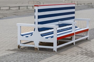 old blue and white wooden bench on the beach promenade