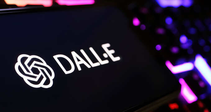 Viersen, Germany - February 9. 2024: Closeup of Smartphone screen with logo lettering of Open AI Dall-E image generator on computer keyboard