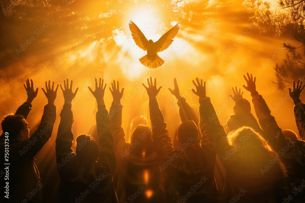 Wall mural Crowd of people raising hands worshiping the Holy Spirit flying over the crowd of believers