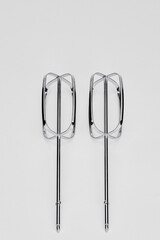 Close-up of mixer whisks on white background