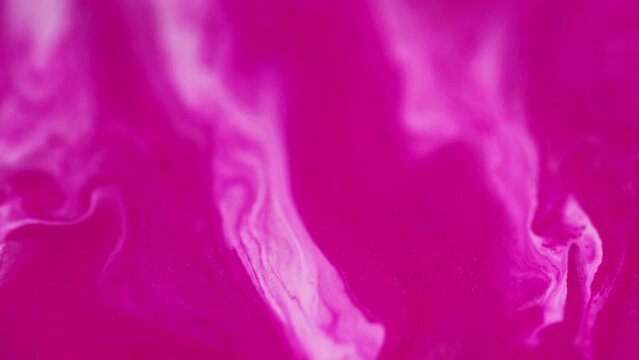 Shimmering paint. Ink flow. Liquid blend. Defocused glowing pink white shiny acrylic pigment water mix stream motion art abstract background.