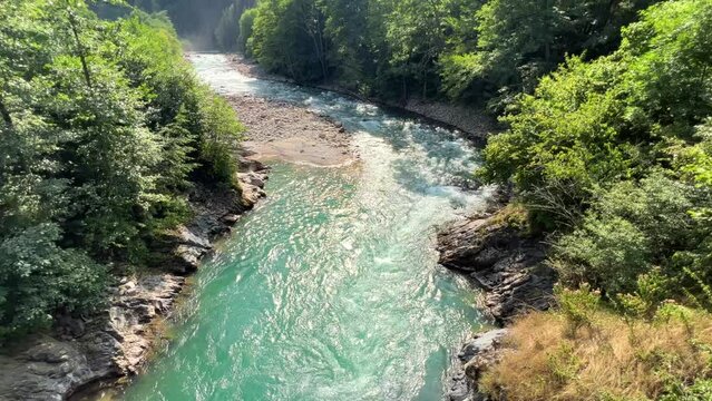 The Bolshaya Laba River. A mountain emerald river in a narrow, sunlit canyon. Bolshaya Laba River near the village of Psemen in Karachay-Cherkessia, Russia. Panoramic view. 4K