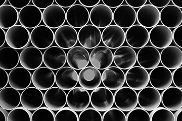 Metal or plastic pipes lie in a row as an industrial background or template for a website or page - 750151900