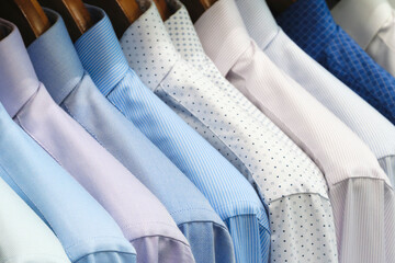 Multi-colored men's shirts on hangers in a store or store - 750152300