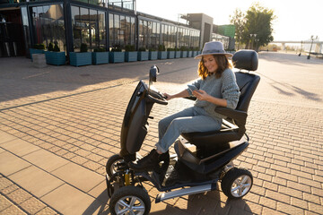 Woman tourist riding a four wheel mobility electric scooter on a city street