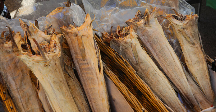 Dried headless stockfish is a popular delicacy for sale at fish market