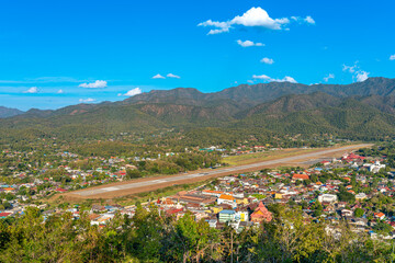 Panoramic view from the Shan Hills to the airport and the town of Mae Hong Son in northern Thailand. The city is located in the Western Thanon Thong Chai range near the border with Myanmar.