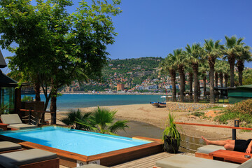 View of the beach and sea with umbrellas and sun loungers, summer sunny day