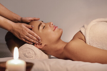 Spa treatment. Young woman enjoying face massage