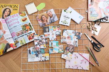 Fototapeta na wymiar Flat lay composition with different photos, magazines, stationery and metal grid on wooden background. Creating vision board