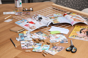 Composition with different photos, magazines and metal grid on wooden table indoors. Creating...
