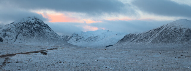 Panorama of a mountain range and the valleycovered with snow in winter. Glen Etive in the Highlands. Scotland