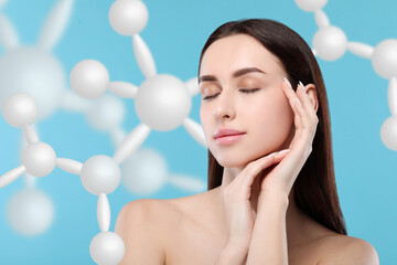 Beautiful woman with perfect healthy skin and molecular model on light blue background. Innovative...