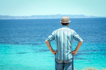 A happy guy near the sea in nature weekend travel