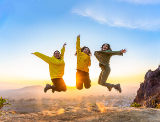 Happiness and excitement are evident in the expression of these young women as they jump in nature....