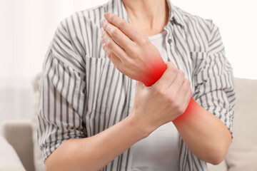 Woman suffering from rheumatism at home, closeup