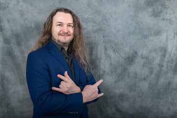 Modern man with long hair in trendy blue suit demonstrating diverse confident postures