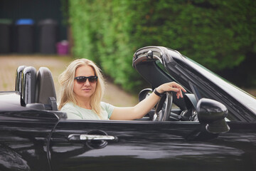 Attractive woman in a cabriolet in the Netherlands